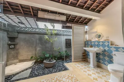 a bathroom with a toilet and a sink at Sol Lila Bali in Canggu
