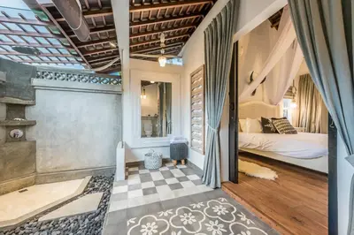 a bedroom with a bed and a checkered floor at Sol Lila Bali in Canggu