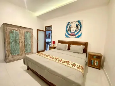 a bedroom with a large bed in a room at Timaya Villa BEST LOCATION in Legian