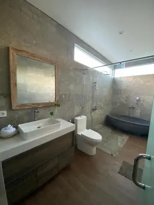 a bathroom with a sink and a toilet and a tub at Puspa Ayu Villas & Apartments in Kuta