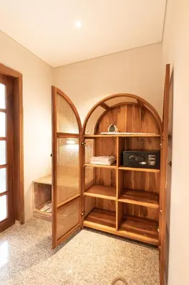 a room with a book shelf and a microwave at Lamoon Villas Berawa in Canggu
