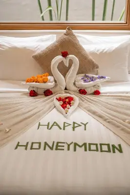 a bed with a happy hanuman sign on it at Lamoon Villas Berawa in Canggu