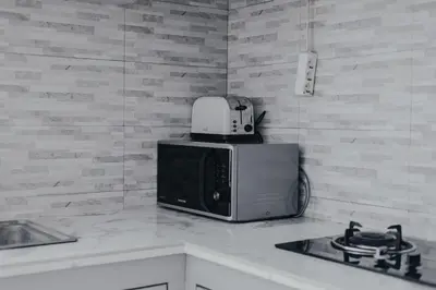 a microwave sitting on top of a kitchen counter at Cozy 2BR Private Pool Villa, Oberoi, Central Seminyak, Bali in Seminyak