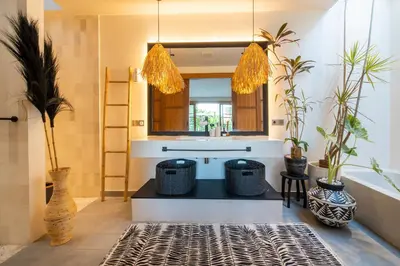 a bathroom with a sink and a tub with plants at Villa Yukiko Canggu in Canggu