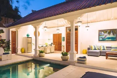 a villa with a swimming pool next to a house at Villa Sintra - 2 BR luxury in tranquil location, walk to beach in Seminyak