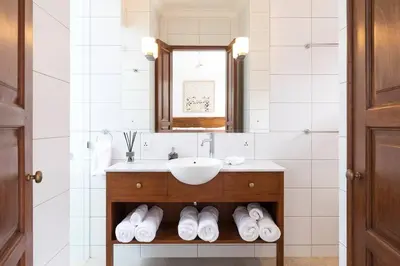 a bathroom with a sink and a mirror at Villa Sintra - 2 BR luxury in tranquil location, walk to beach in Seminyak