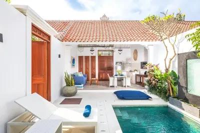 a villa with a swimming pool in front of a house at Casa Sintra - Romantic, tranquil hideaway, walk to beach in Seminyak