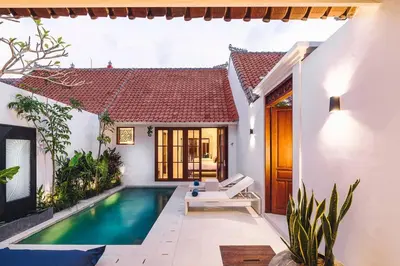 a villa with a swimming pool and a house at Casa Sintra - Romantic, tranquil hideaway, walk to beach in Seminyak