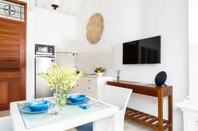 a kitchen with a table with blue dishes on it at Casa Sintra - Romantic, tranquil hideaway, walk to beach in Seminyak