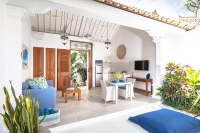 a living room with a couch and a table at Casa Sintra - Romantic, tranquil hideaway, walk to beach in Seminyak