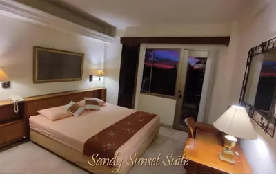 a bedroom with a bed and a desk and a window at Jayakarta Residence - Sandy Sunset Suite 1BR - 6432 in Seminyak