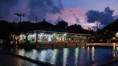a building with a pool in front of it at night at Jayakarta Residence - Sandy Sunset Suite 1BR - 6432 in Seminyak