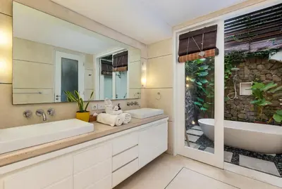 a bathroom with two sinks and a tub at Villa Iluka by SooBali in Seminyak