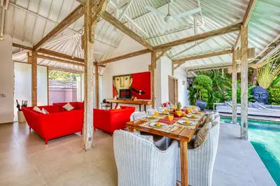 a living room with a table and chairs and a pool at PROMO 4 bd Spacious villa in strategic location in Seminyak