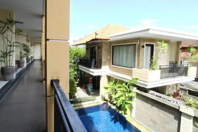 a view from the balcony of a house with a swimming pool at Kondra Premiere Guest House Kuta in Kuta