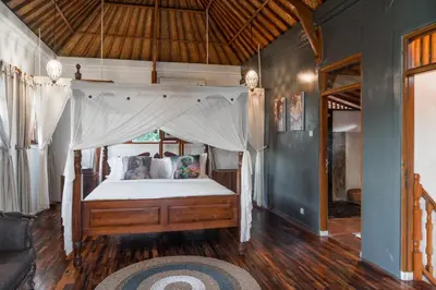 a bedroom with a bed with a canopy at Ocean Star Villa Four Bedrooms Seminyak in Seminyak