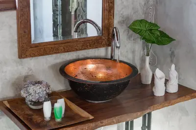 a wooden counter with a sink and a mirror at Ocean Star Villa Four Bedrooms Seminyak in Seminyak