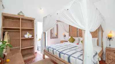 a bedroom with a bed with a canopy at Ocean Star 2 in Seminyak