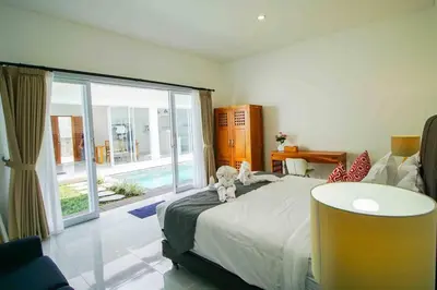a bedroom with a bed with a teddy bear sitting on it at Villa Akmali Seminyak Drupadi 2 Bedrooms w/Pool 5mins to Beach in Seminyak