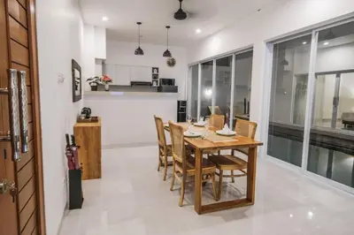 a kitchen and dining room with a wooden table and chairs at Villa Akmali Seminyak Drupadi 2 Bedrooms w/Pool 5mins to Beach in Seminyak