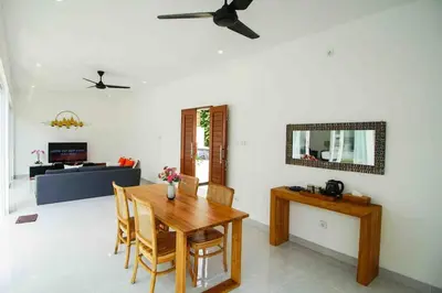 a living room with a wooden table and chairs at Villa Akmali Seminyak Drupadi 2 Bedrooms w/Pool 5mins to Beach in Seminyak