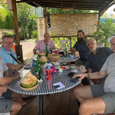 a group of men sitting around a table at PIMA Homestay in Pesanggaran
