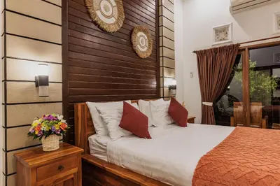 a bedroom with a bed with a wooden headboard at Padma Villa I in Legian