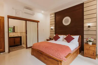 a bedroom with a large bed and a bathroom at Padma Villa I in Legian