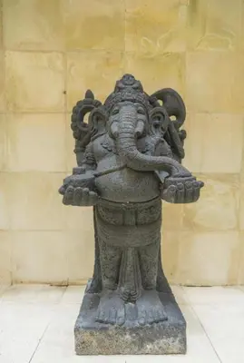 a statue of an elephant standing in front of a wall at Mai Villa in Jimbaran