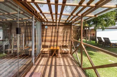 a pergola with a table and chairs on a deck at Bali WOW! Bungalows, Nusa Dua Benoa in Nusa Dua