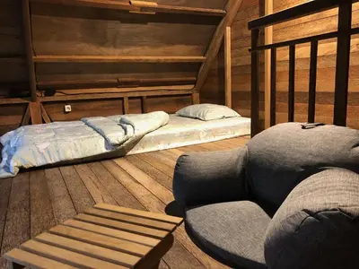 a room with two bunk beds and a couch at Bali WOW! Bungalows, Nusa Dua Benoa in Nusa Dua