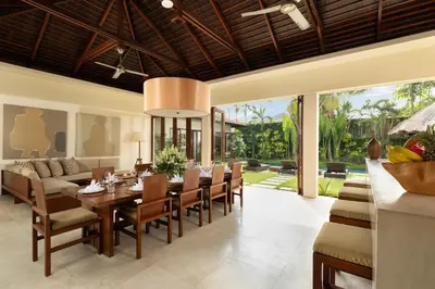 a dining room with a table and chairs at The Suar Seminyak by Nakula in Seminyak