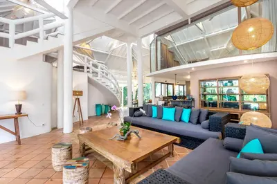 a living room with blue couches and a table at La Villa Oberoi (6 BR) in Seminyak