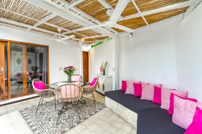 a living room with a couch and chairs and a table at La Villa Oberoi (2 BR) in Seminyak