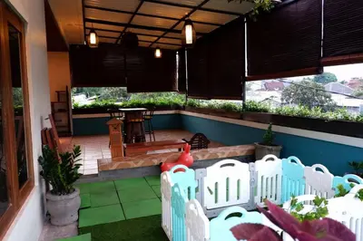 a patio with a white fence and a table at Villa Bale Damai Denpasar in Seminyak