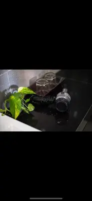a black flashlight and a plant on a table at Legian Bisma Suite in Seminyak