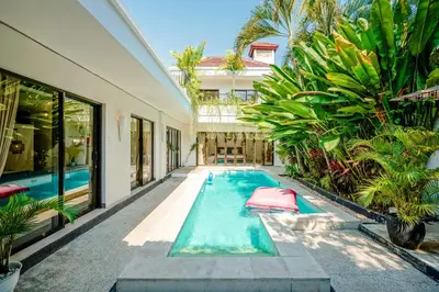 a swimming pool in the middle of a house at Lalita Villas Seminyak in Seminyak
