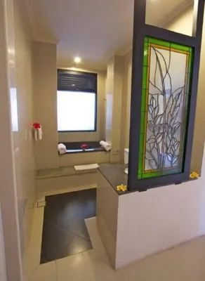 a bathroom with a sink with a stained glass window at 5 Bedroom Holiday Villa - Kuta Regency B8 in Kuta