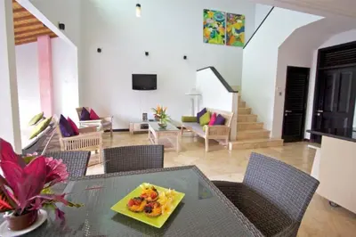 a living room with a table with a plate of food at 5 Bedroom Holiday Villa - Kuta Regency B8 in Kuta