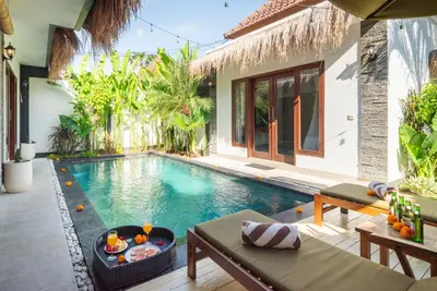 a swimming pool in the middle of a house at Villa bella wilson in Seminyak