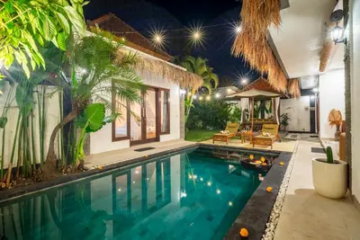 a swimming pool in a villa at night at Villa bella wilson in Seminyak