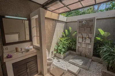 a bathroom with a sink and a mirror at Panorama Cottages I in Legian