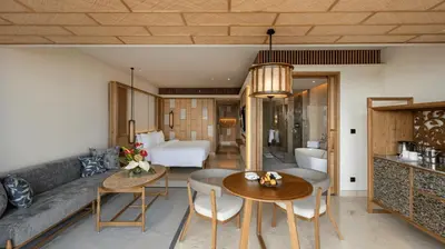 a living room with a couch and a table at AYANA Segara Bali in Jimbaran