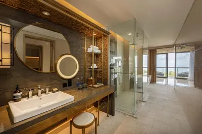 a bathroom with a sink and a glass shower at AYANA Segara Bali in Jimbaran