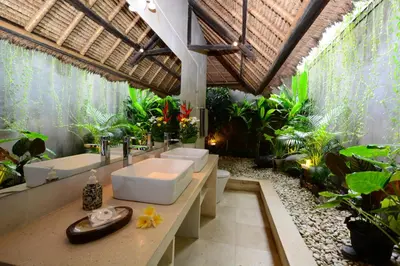 a bathroom with two sinks and a bunch of plants at Villa Elleo in Seminyak