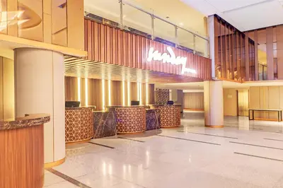 a lobby of a hotel with a large lobbyasteryasteryasteryasteryasteryasteryastery at Sunday Hotel Arshika Sunset Road in Kuta