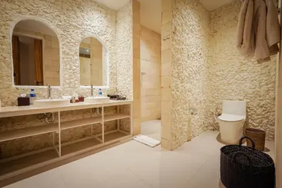 a bathroom with two sinks and a toilet and a mirror at Bias Villa Seminyak in Seminyak