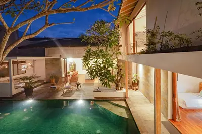 an indoor pool in a house with plants at Bias Villa Seminyak in Seminyak