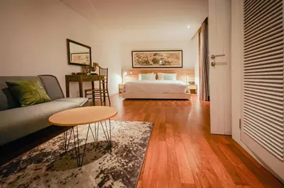 a living room with a bed and a table at Bias Villa Seminyak in Seminyak
