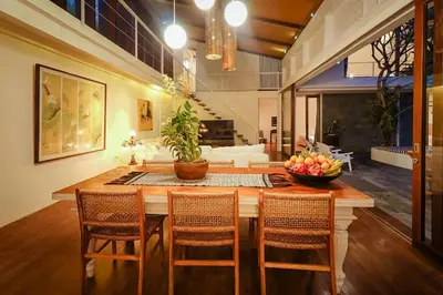 a kitchen with a table with chairs and a bowl of fruit at Bias Villa Seminyak in Seminyak